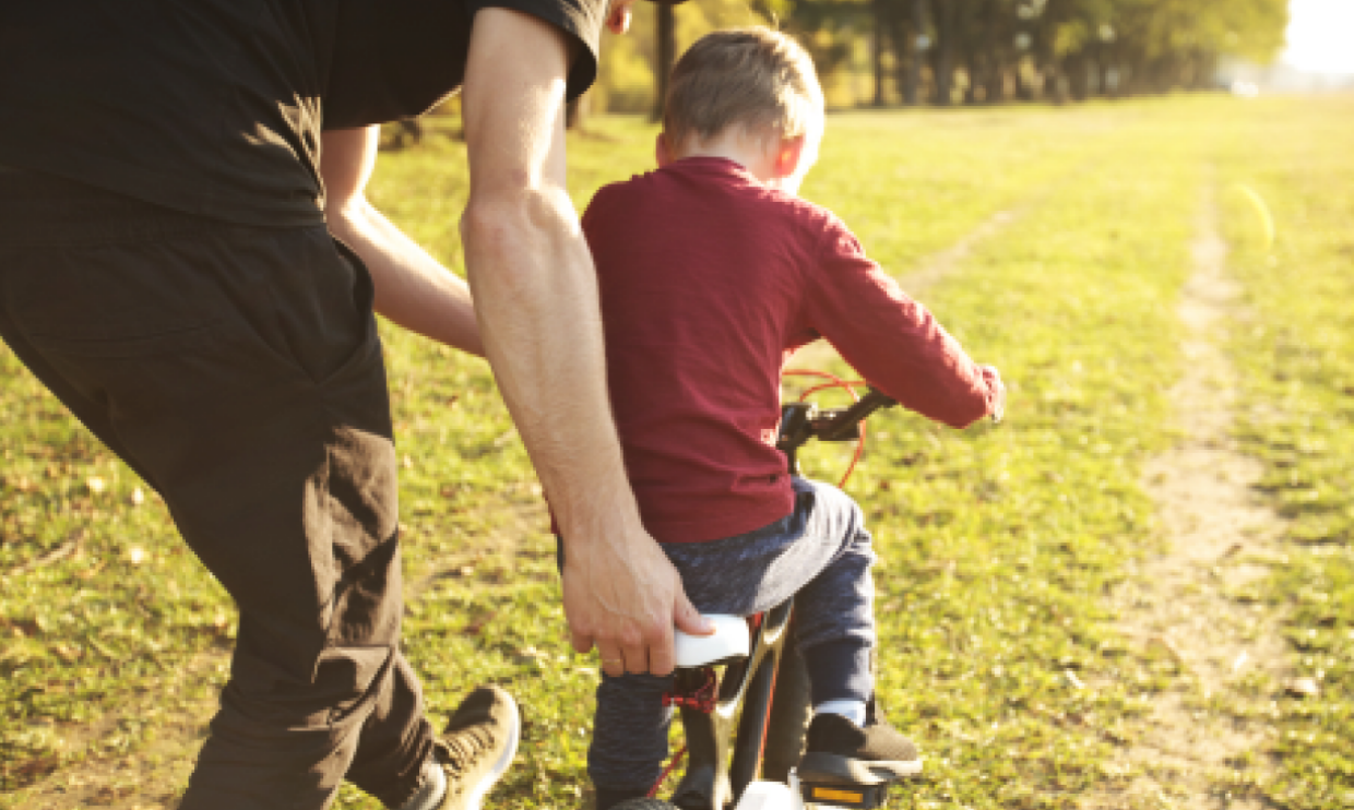 Child learning to ride a bike
