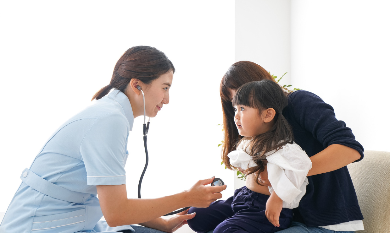 Nurse helping child and parent