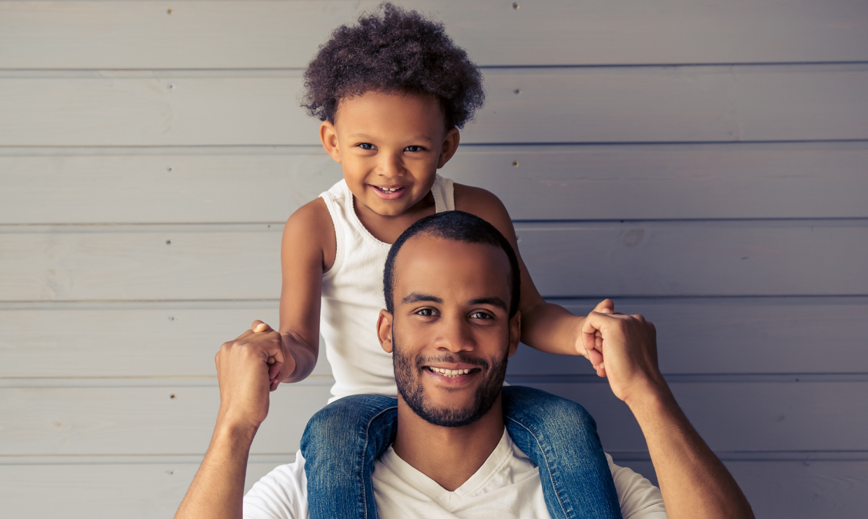 Parent with child sitting on their shoulders