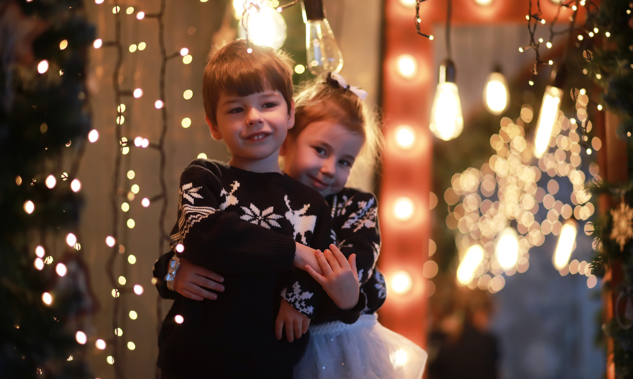 Children surrounded by holiday lights