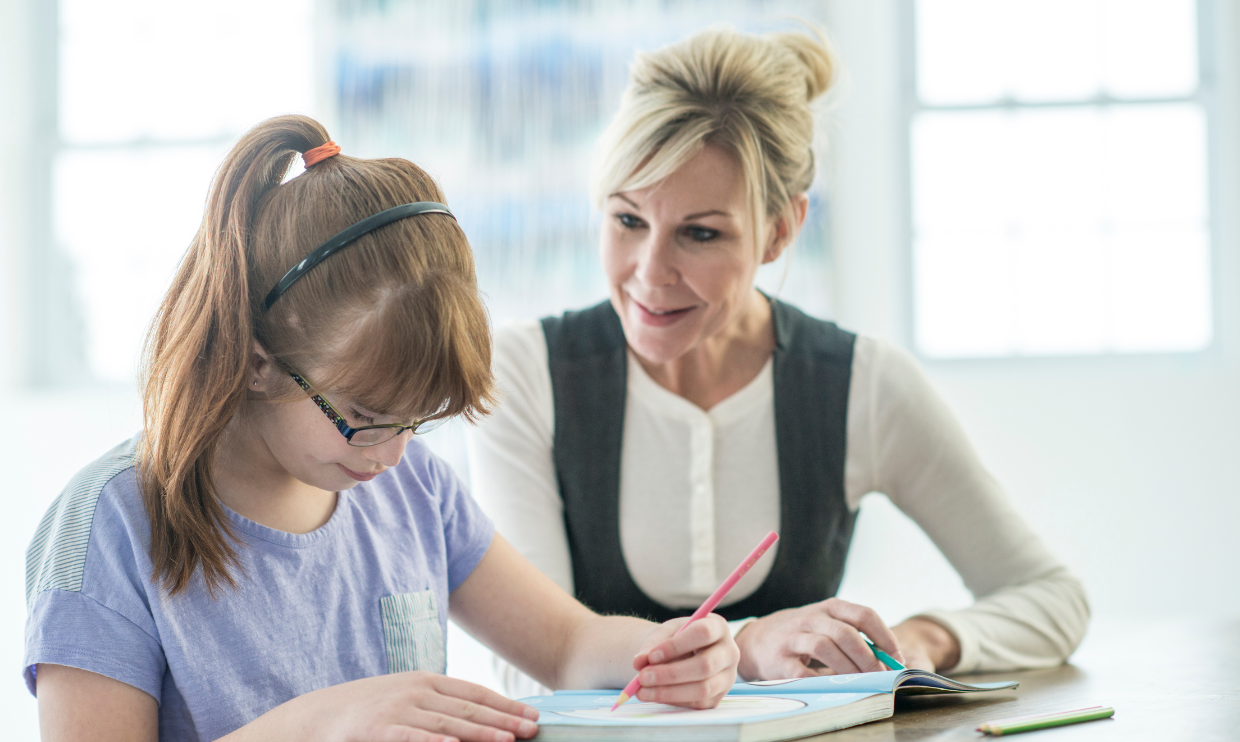 Adult helping student with homework