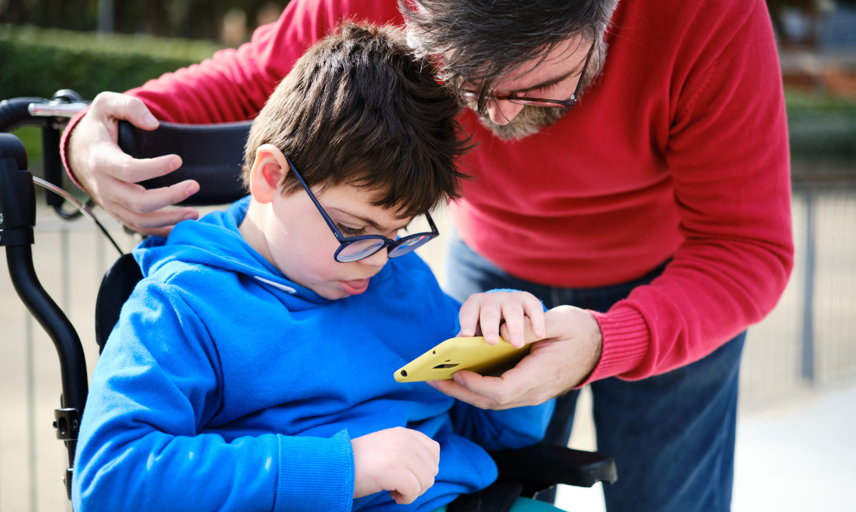Child and caregiver looking at phone