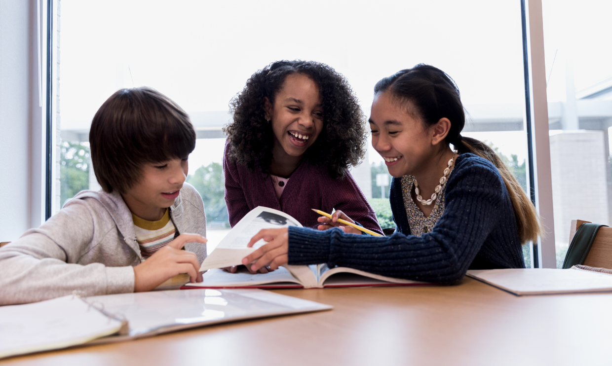 Students looking at a textbook