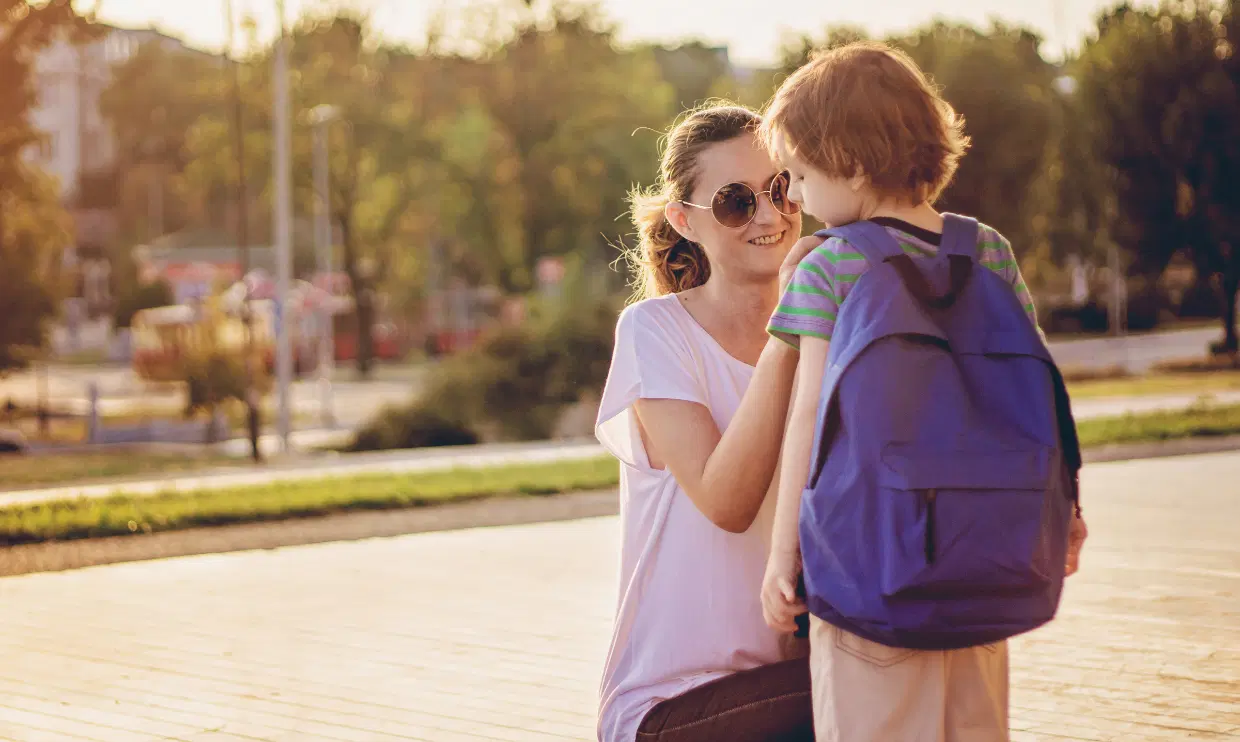 Parent checking child's backpack